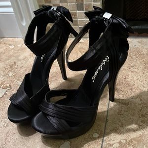 Black satin high heels with bow on back